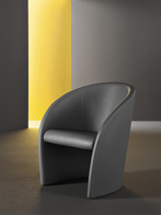 Intervista armchair by Poltrona Frau styled in a contemporary interior highlighting its sculptural form and smooth surfaces