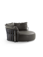 Scarlett sofa by Poltrona Frau displayed as a standalone piece highlighting its circular seating form and enclosing back structure