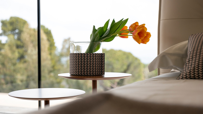 Leather-wrapped pot by Poltrona Frau from the Gli Oggetti accessories collection styled on a side table as a decorative leather container