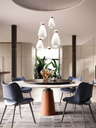 Cluster pendant lights arranged above a round table, contributing to a warm and inviting dining atmosphere