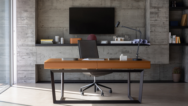 Peek-a-Book Desk by Poltrona Frau designed by Roberto Lazzeroni displayed in a modern workspace highlighting the refined executive desk with sculptural base