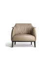 Front view of the Archibald armchair by Poltrona Frau highlighting its soft contours and structured base