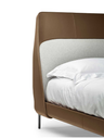 Close-up of the Coupé bed headboard showing the central panel and surrounding upholstered border