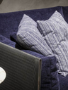 Close-up of the Clayton sofa by Poltrona Frau showing the loose back cushions and textured upholstery