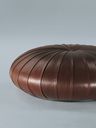 Esedra by Poltrona Frau displayed as a standalone piece showing the rounded form and segmented upholstery
