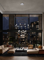 Suspended chandelier composed of multiple glass elements arranged above a dining table, creating a focal lighting feature within a contemporary interior