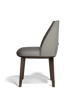 Archibald dining chair by Poltrona Frau shown from the side highlighting its slim seat profile, angled backrest and elegant dining function.