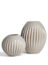 Shiwa vase by Poltrona Frau shown as a two piece composition highlighting contrasting rounded forms, ribbed surfaces and refined decorative use.