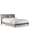 Three-quarter view of the Times bed displaying its elevated frame and distinctive headboard structure