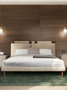 Front view of the Times bed styled with pillows and bedside lighting, highlighting its structured headboard and refined proportions