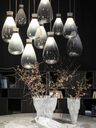 Single pendant lamp shown against a dark background, emphasising its elongated glass form and suspended structure