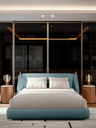 Stock’n Roll night table placed beside a bed, showing its compact cylindrical form used as a bedside surface