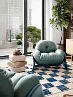 Squash rug placed in a lounge setting with seating, illustrating its role in structuring the space and adding visual depth