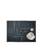 Dizzy rug by Poltrona Frau displayed in a styled setting with furniture, showing the overall layout and scale