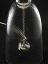 Close-up of the lamp’s internal structure and suspended element, highlighting craftsmanship and delicate construction