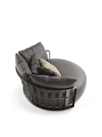 Angled view of the Scarlett sofa by Poltrona Frau showing the curved seat and supportive backrest with integrated structure