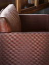 Close-up detail of the upholstery on the Clayton armchair by Poltrona Frau showing texture and refined craftsmanship