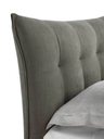 Headboard detail of the Aurora Tre bed highlighting soft padding and panelled structure