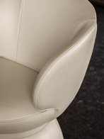 Detailed view of the curved backrest wrapping around the seat, emphasising the enveloping shape and supportive design