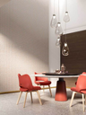 Pendant lights hanging above a table near a window, casting soft light and enhancing the interior setting