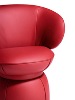 Close-up of the armchair’s seat and lower structure, showing the soft curvature and seamless transition between base and seating surface
