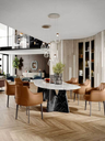 Archibald Large dining chairs arranged around a dining table in a refined interior, showing how the chairs integrate into a complete dining setting