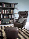 Mamy Blue armchair with matching ottoman by Poltrona Frau styled in an interior highlighting comfort and lounge design