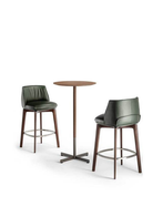 High table from the Bob Bistrot collection styled with stools, highlighting the relationship between seating height and the elevated tabletop
