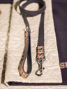Pet Collection leash by Poltrona Frau styled with collar on a surface highlighting braided leather and crafted hardware