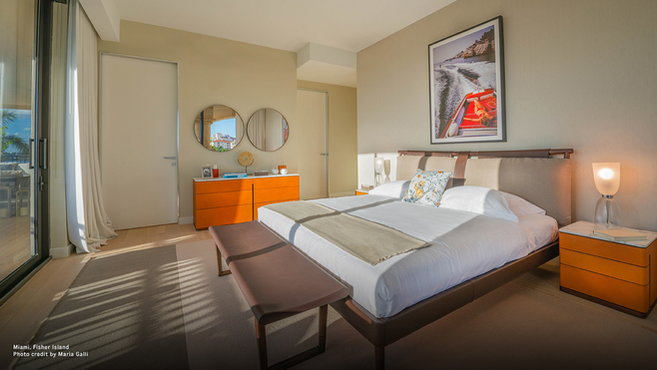 Times bed by Poltrona Frau styled in a contemporary bedroom interior with bedside tables and bench at the foot of the bed, highlighting the upholstered bed within a modern residential setting