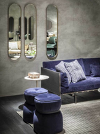 Clayton sofa by Poltrona Frau placed in a contemporary interior with tables and accessories, highlighting its structured frame and relaxed seating