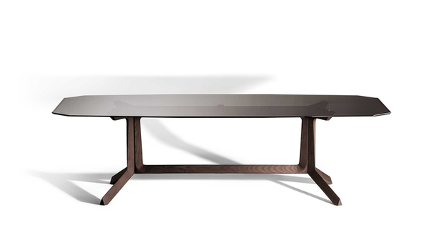 Othello Rectangular Table by Poltrona Frau designed by Roberto Lazzeroni displayed in studio view highlighting the sculptural rectangular dining table with architectural base