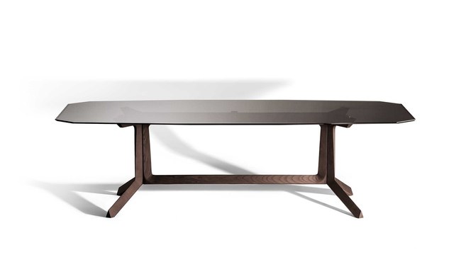 Othello Rectangular Table by Poltrona Frau designed by Roberto Lazzeroni displayed in studio view highlighting the sculptural rectangular dining table with architectural base