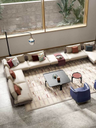Get Back sofa by Poltrona Frau styled in a living area with tables and accessories, showing its integration into a refined environment
