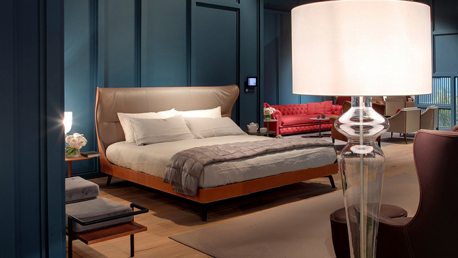 Mamy Blue Bed by Poltrona Frau designed by Roberto Lazzeroni displayed within a modern bedroom setting highlighting the sculptural upholstered bed design
