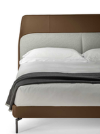 Front view of the Coupé bed presenting its structured headboard and clean-lined upholstered frame