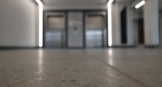Macro of polished terrazzo surface with fine stone inlays and mirror-like reflection.