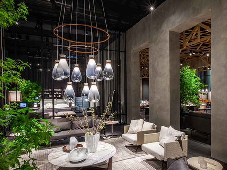 Soffi Chandelier by Poltrona Frau designed by GamFratesi displayed within a contemporary lounge interior highlighting the sculptural designer chandelier above a seating arrangement