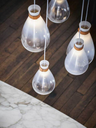 Detailed view of the pendant lights with visible internal elements and refined construction
