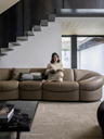 Parka modular sofa by Poltrona Frau shown in use with a person seated, demonstrating comfort and relaxed seating