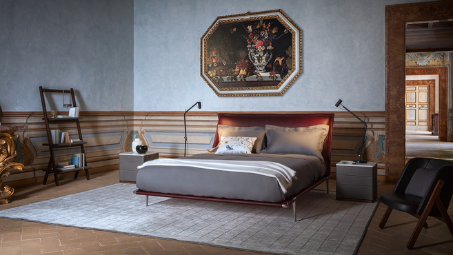 Ren Bookcase by Poltrona Frau designed by Neri and Hu shown within a bedroom interior highlighting the sculptural open shelving bookcase