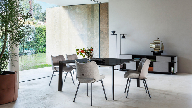 Homey table by Poltrona Frau designed by GamFratesi arranged within an architectural dining interior highlighting the minimalist table design