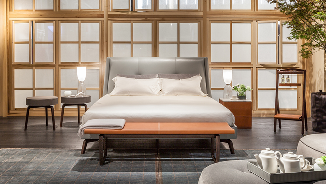 Fidelio bench by Poltrona Frau designed by Roberto Lazzeroni styled at the foot of a designer bed within a contemporary bedroom interior