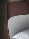 Headboard detail of the Coupé bed highlighting the contrast between the central panel and surrounding upholstered frame