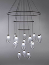 Full view of the chandelier showing the circular frame with multiple suspended glass elements arranged in tiers