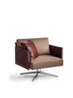 Angled view of the Clayton armchair by Poltrona Frau highlighting its swivel base and architectural form