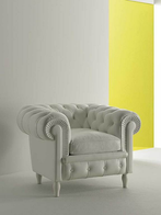 Chester armchair by Poltrona Frau shown in a refined setting highlighting its iconic tufted form and rolled arms