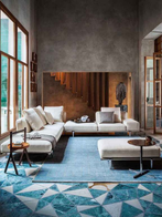 Let It Be sofa by Poltrona Frau styled within a refined living room with tables and accessories, showing its integration into the interior