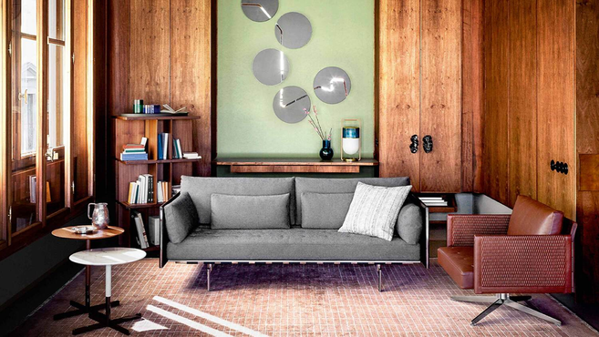 Clayton sofa by Poltrona Frau designed by Jean-Marie Massaud styled within a contemporary living room interior highlighting the elegant upholstered lounge seating design