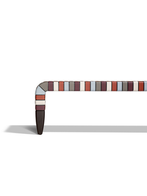Side profile of the Brera 90th Anniversary bench by Poltrona Frau highlighting the elongated form and supporting structure